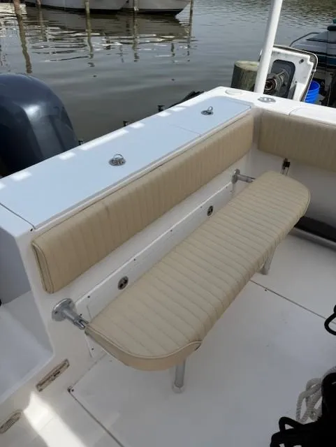 Slide: The Image of 2006 Angler 2600CC Limited Edition boat with beige seating, docked by the water. - 25