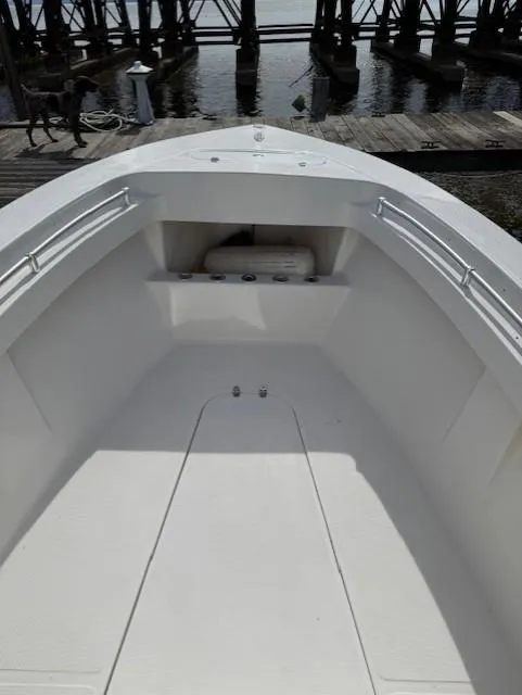 Slide: The Image of 2006 Angler 2600CC Limited Edition boat bow, docked at a marina. - 7