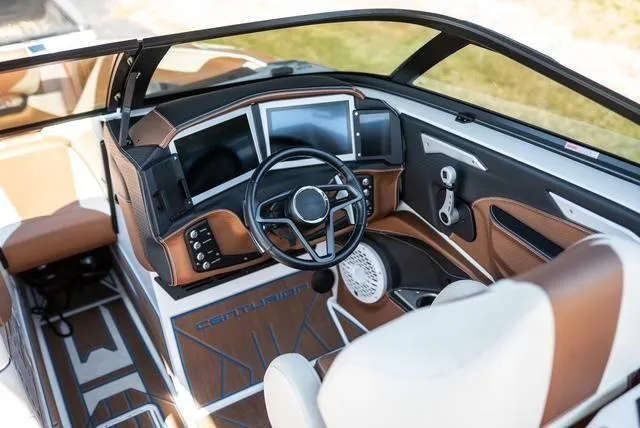 Slide: The Image of 2022 Centurion Ri265 boat interior with modern dashboard and steering wheel. - 13