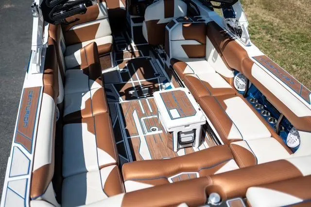 Slide: The Image of 2022 Centurion Ri265 boat interior with luxurious brown and white seating and modern design. - 14