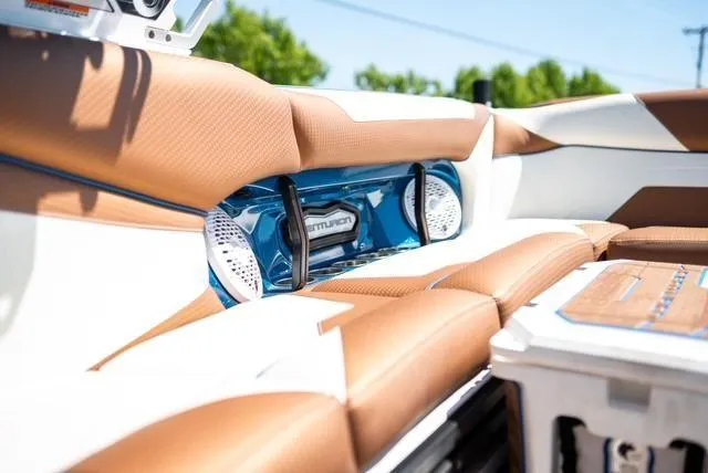 Slide: The Image of 2022 Centurion Ri265 boat interior with brown leather seats and built-in speakers. - 16