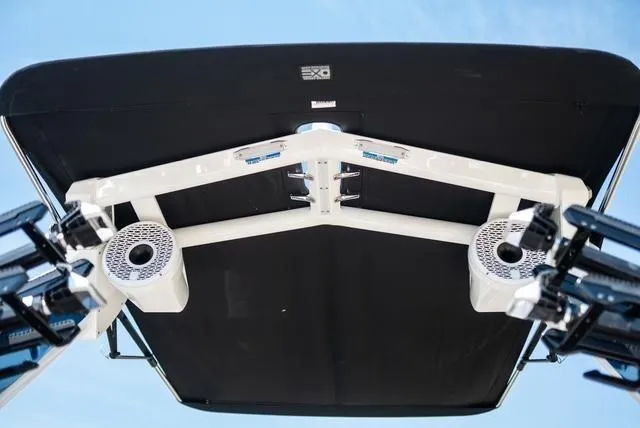 Slide: The Image of 2022 Centurion Ri265 boat tower with speakers and black canopy against blue sky. - 18