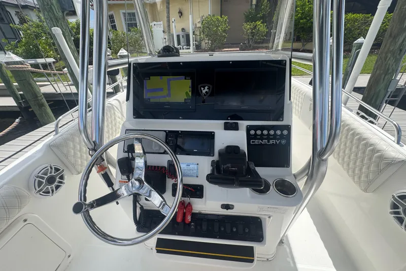 Slide: The Image of Cockpit of a 2007 Century 2600CC boat with steering wheel and navigation system. - 11