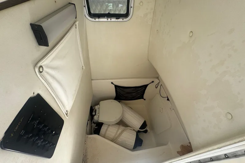 Slide: The Image of Interior cabin of a 2007 Century 2600CC boat with storage and toilet. - 14