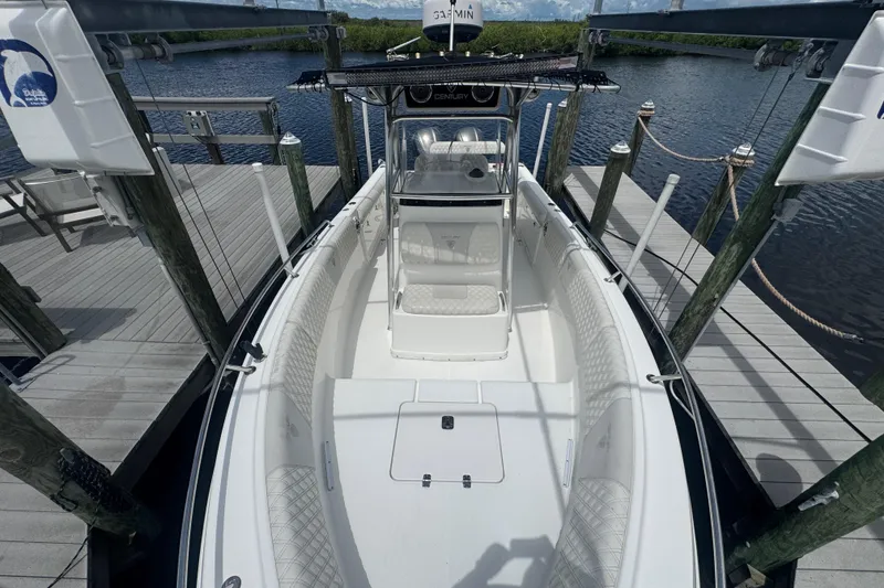 Slide: The Image of 2007 Century 2600CC boat docked at a marina, showcasing spacious deck and seating. - 20