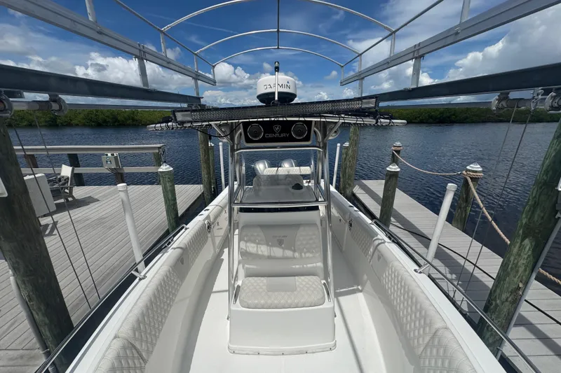 Slide: The Image of 2007 Century 2600CC boat docked, featuring a spacious deck and modern navigation equipment. - 22