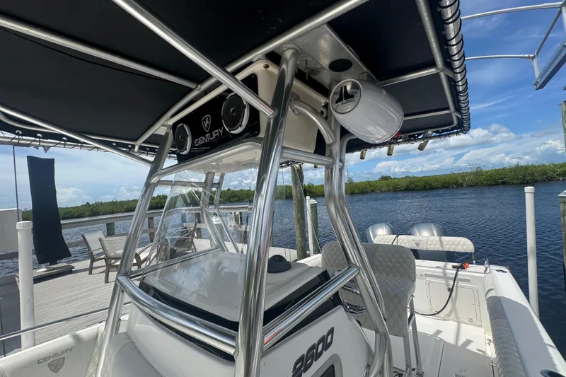 Slide: The Image of 2007 Century 2600CC boat with T-top, docked by a scenic waterfront. - 24