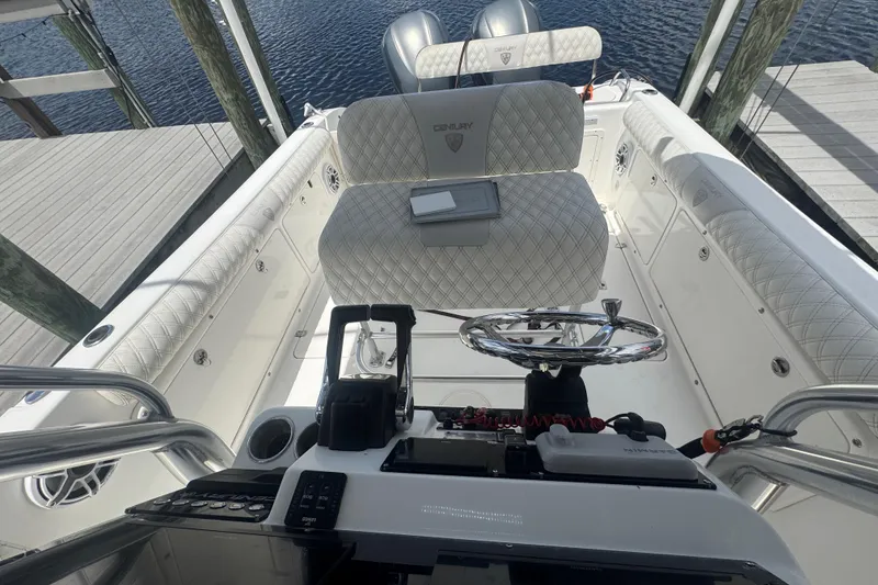Slide: The Image of 2007 Century 2600CC boat interior with steering wheel and cushioned seating. - 25