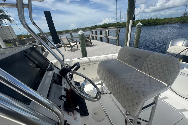 Slide: The Image of 2007 Century 2600CC boat interior with steering wheel and seating, dockside view. - 27