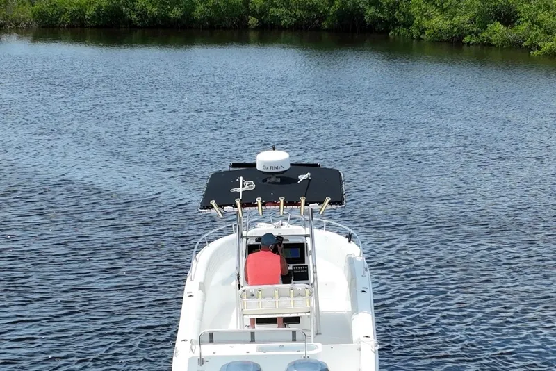 Slide: The Image of 2007 Century 2600CC boat on calm water, surrounded by lush greenery. - 6
