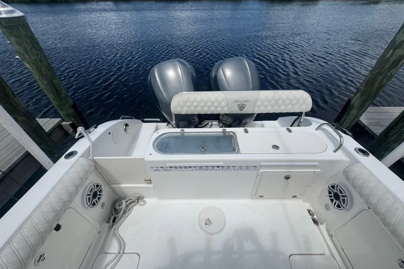 Slide: The Image of 2007 Century 2600CC boat interior with dual engines, docked by the water. - 9