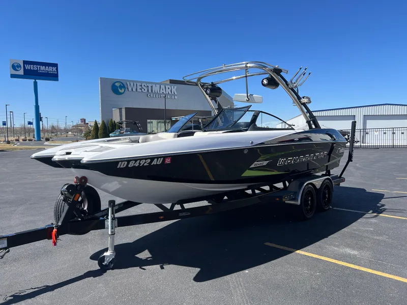 Slide: The Image of 2014 Malibu W22MXZ boat on trailer in parking lot near Westmark Credit Union. - 5
