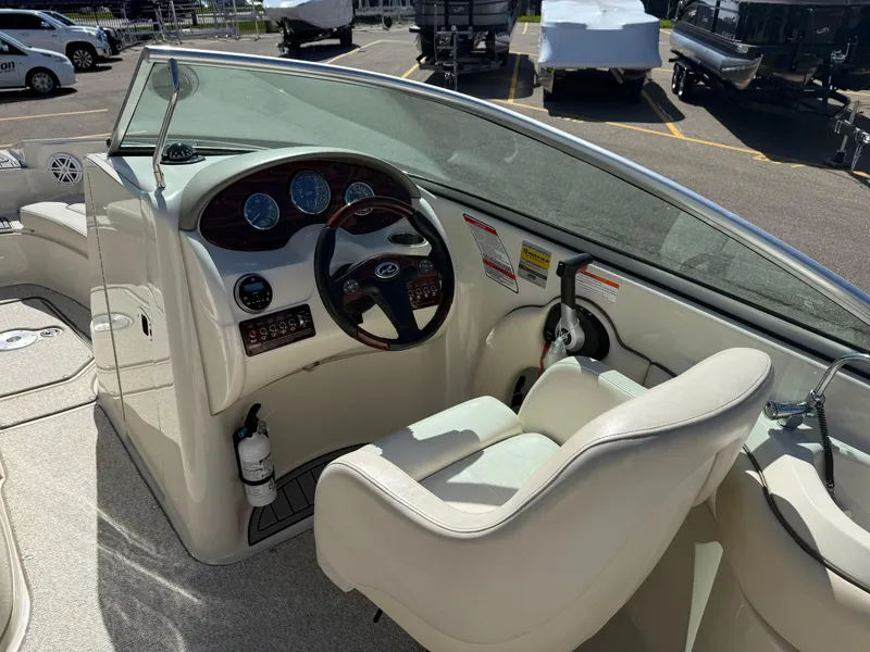 Slide: The Image of 2008 Sea Ray 220 boat interior with steering wheel and dashboard controls. - 10