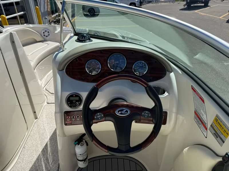 Slide: The Image of Steering console of a 2008 Sea Ray 220 boat with gauges and controls. - 11