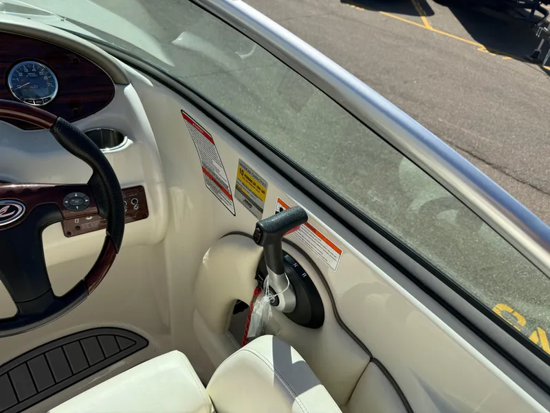 Slide: The Image of Interior of a 2008 Sea Ray 220 boat showing steering wheel and throttle controls. - 12