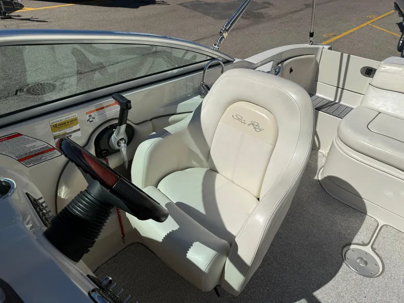 Slide: The Image of 2008 Sea Ray 220 boat interior with steering wheel and white captain's chair. - 13