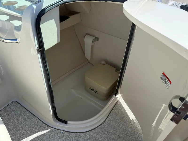 Slide: The Image of Compact bathroom in 2008 Sea Ray 220 boat with portable toilet and storage. - 15