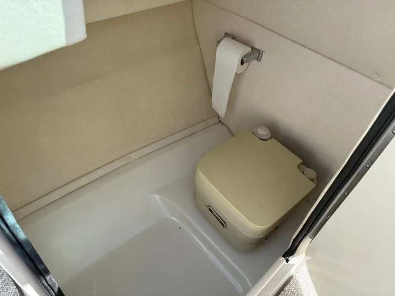 Slide: The Image of Compact bathroom in 2008 Sea Ray 220 boat with portable toilet and toilet paper holder. - 16