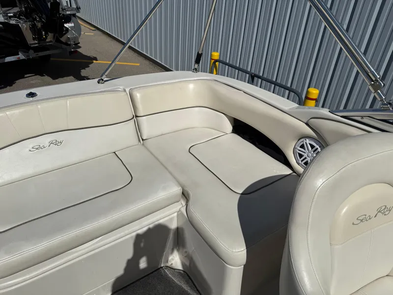 Slide: The Image of 2008 Sea Ray 220 boat interior with white leather seating and speaker. - 18