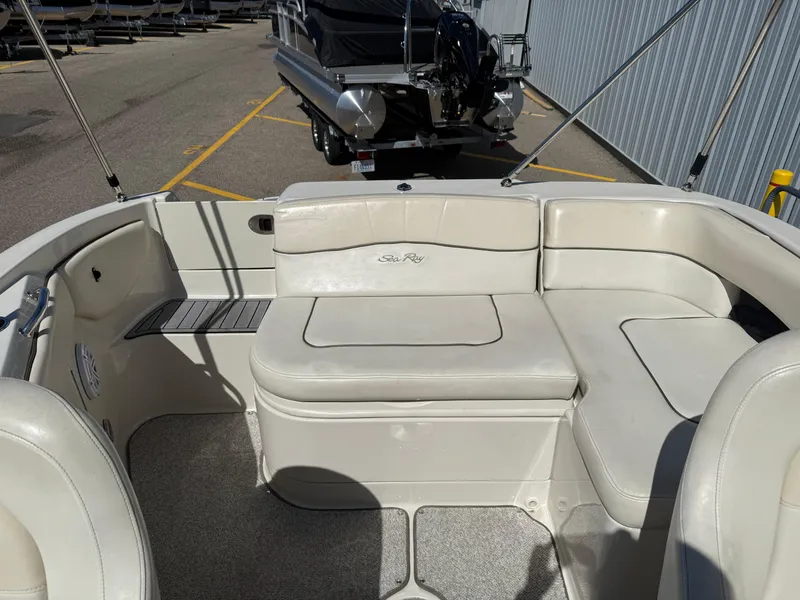 Slide: The Image of 2008 Sea Ray 220 boat interior with white seating and carpeted floor. - 19