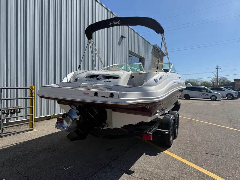 Slide: The Image of 2008 Sea Ray 220 boat on trailer, parked beside a metal building. - 3