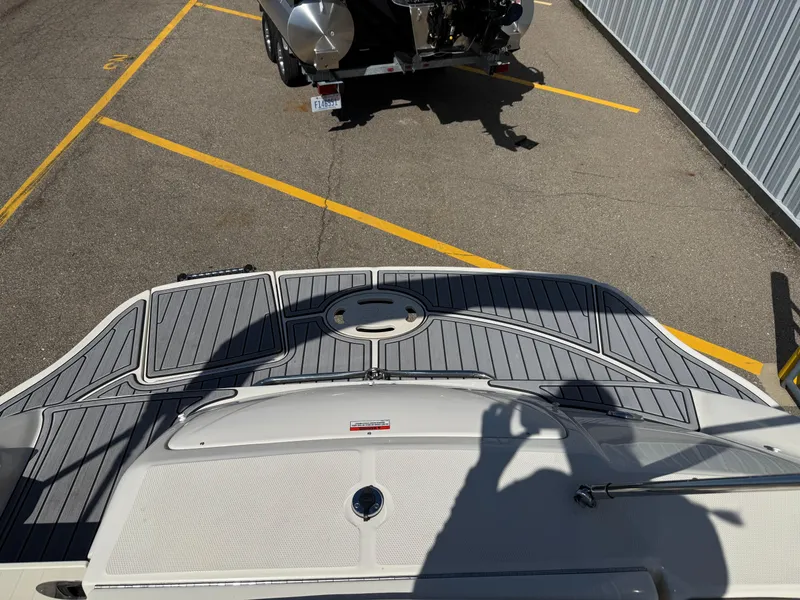 Slide: The Image of 2008 Sea Ray 220 boat with gray deck, parked near a trailer. - 8