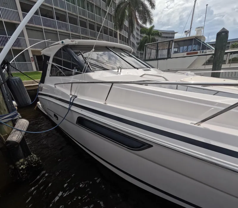 Slide: The Image of 2015 Regal 35 Sport Coupe docked near waterfront buildings. - 15