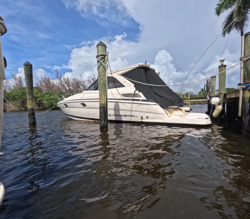 Slide: The Image of 2015 Regal 35 Sport Coupe docked on a sunny day with blue skies. - 2