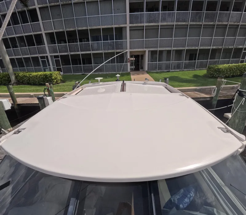 Slide: The Image of 2015 Regal 35 Sport Coupe docked near a modern building. - 23