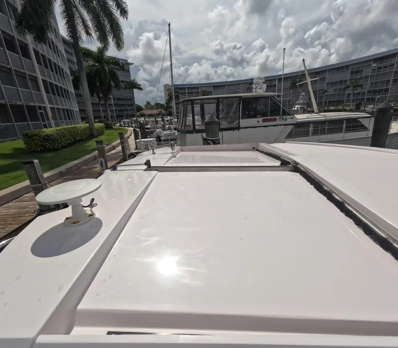 Slide: The Image of 2015 Regal 35 Sport Coupe docked at marina with cloudy sky backdrop. - 24