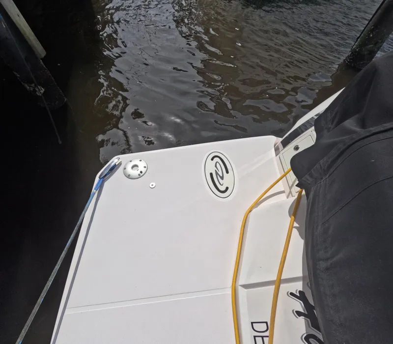 Slide: The Image of 2015 Regal 35 Sport Coupe boat deck near water, showing mooring lines. - 27