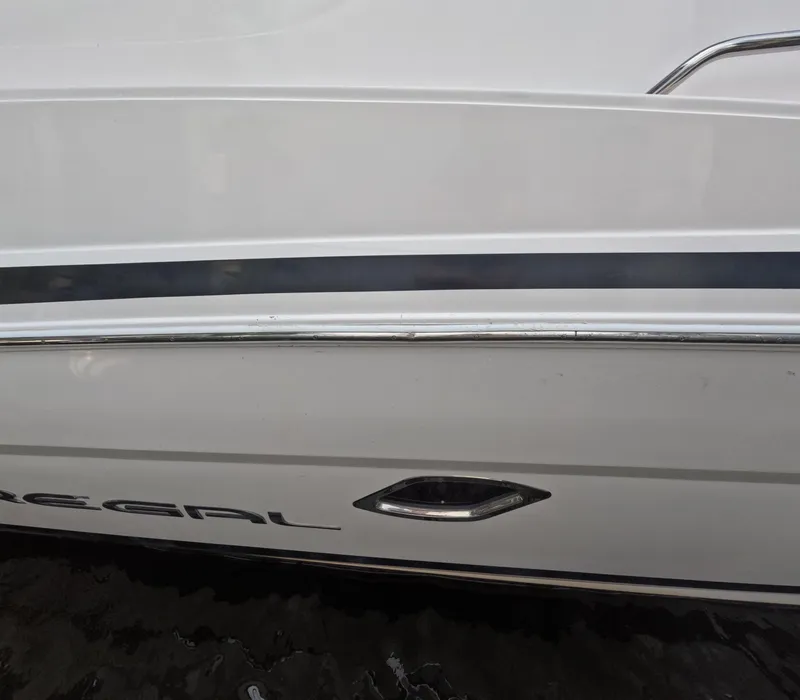 Slide: The Image of 2015 Regal 35 Sport Coupe boat side view with sleek design and logo. - 30