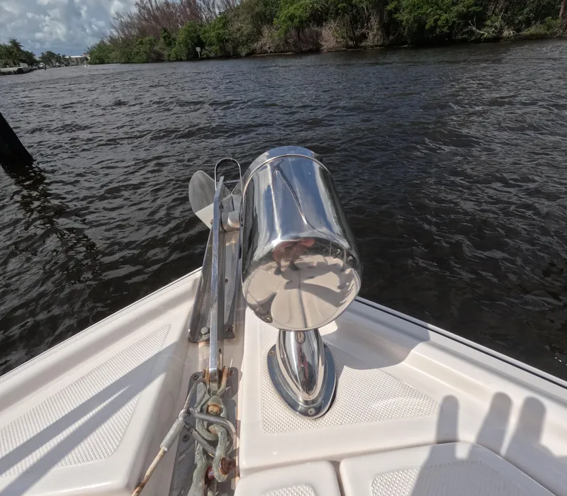 Slide: The Image of Bow of 2015 Regal 35 Sport Coupe on water, featuring anchor and stainless steel fittings. - 31