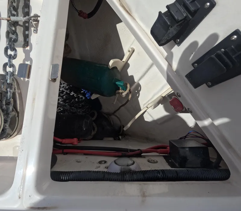 Slide: The Image of Storage compartment of a 2015 Regal 35 Sport Coupe boat, showing chains and equipment. - 32