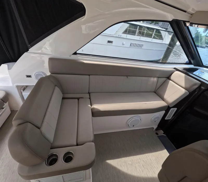 Slide: The Image of Interior of a 2015 Regal 35 Sport Coupe with beige seating and window view. - 42