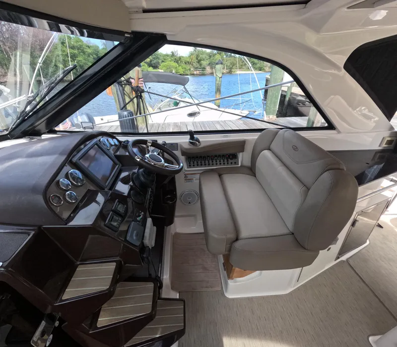 Slide: The Image of 2015 Regal 35 Sport Coupe cockpit with modern controls and comfortable seating. - 48