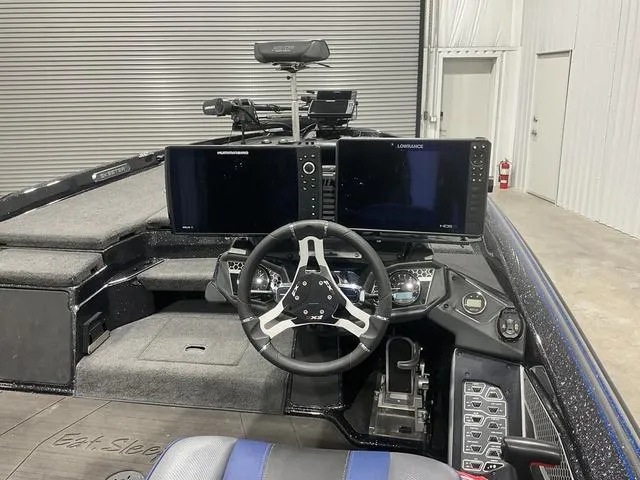 Slide: The Image of 2022 Skeeter FXR21 Select boat cockpit with dual screens and steering wheel. - 11