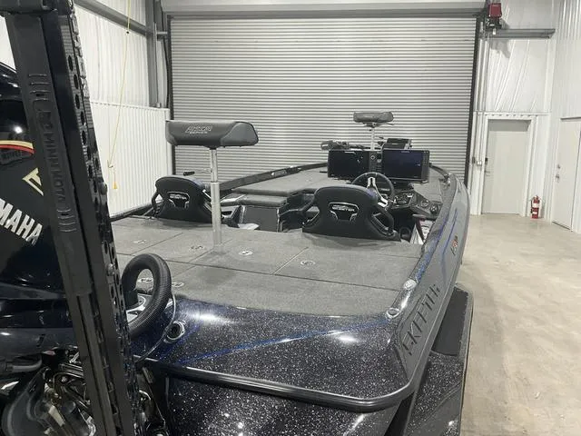 Slide: The Image of 2022 Skeeter FXR21 Select bass boat in a garage, featuring Yamaha engine and advanced electronics. - 13