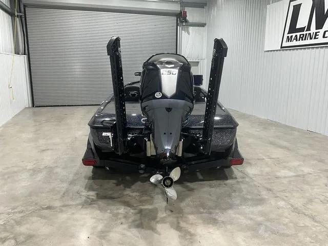 Slide: The Image of 2022 Skeeter FXR21 Select boat in garage, rear view with motor and propeller. - 3