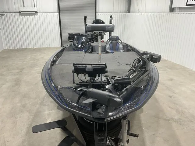 Slide: The Image of 2022 Skeeter FXR21 Select bass boat in a garage, featuring advanced fishing equipment. - 8