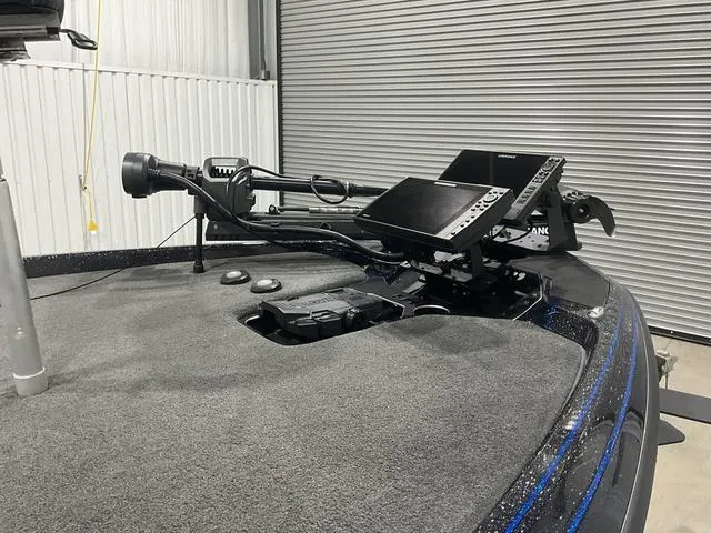 Slide: The Image of 2022 Skeeter FXR21 Select boat with advanced navigation equipment in a garage setting. - 9