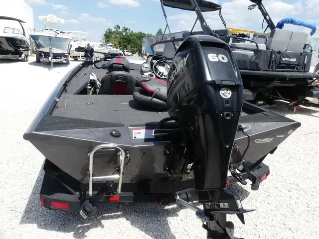 Slide: The Image of 2019 Ranger RT178C boat with Mercury 60 engine, parked on gravel lot. - 3
