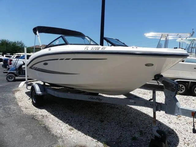 Slide: The Image of 2017 Sea Ray SPX 190 OB boat cruising on calm water at sunset. - 1