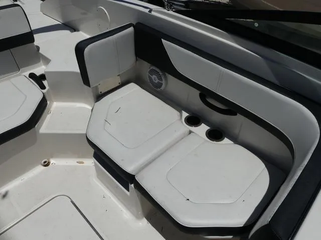 Slide: The Image of 2017 Sea Ray SPX 190 OB boat interior with cushioned seating and cup holders. - 10