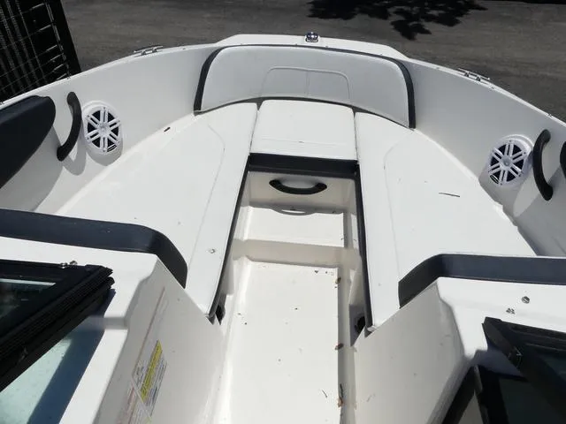 Slide: The Image of 2017 Sea Ray SPX 190 OB boat interior with white seating and speakers. - 11