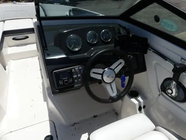 Slide: The Image of 2017 Sea Ray SPX 190 OB boat cockpit with steering wheel and dashboard controls. - 6