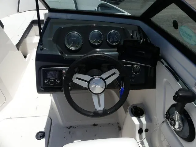 Slide: The Image of 2017 Sea Ray SPX 190 OB boat dashboard with steering wheel and controls. - 7