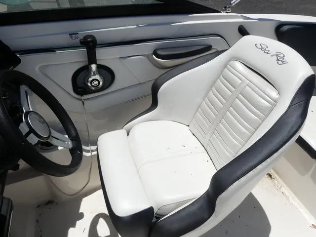 Slide: The Image of 2017 Sea Ray SPX 190 OB boat interior with steering wheel and white captain's seat. - 8