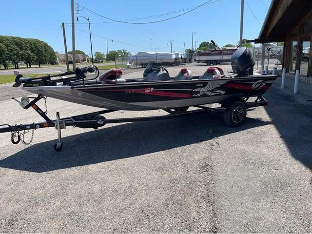 Slide: The Image of 2015 G3 Eagle Talon 17 DLX boat on trailer, parked outdoors. - 2