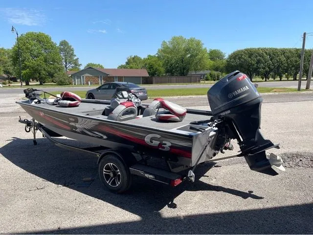 Slide: The Image of 2015 G3 Eagle Talon 17 DLX boat with Yamaha motor on trailer, parked outdoors. - 4